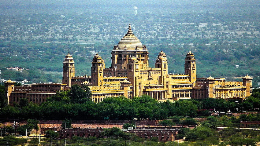 Umaid Bhawan in Jodhpur, Rajasthan, captured from a slightly elevated viewpoint, with the cityscape visible in the background, showcasing its grandeur and architectural beauty