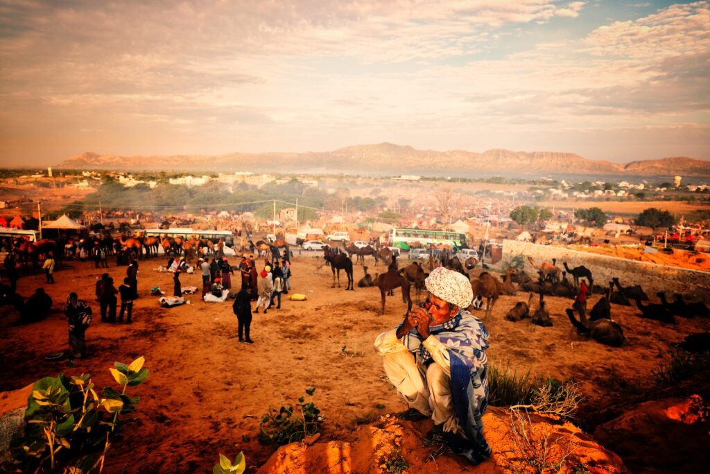 Elderly Gentleman Immersed in Pushkar Fair Vibes