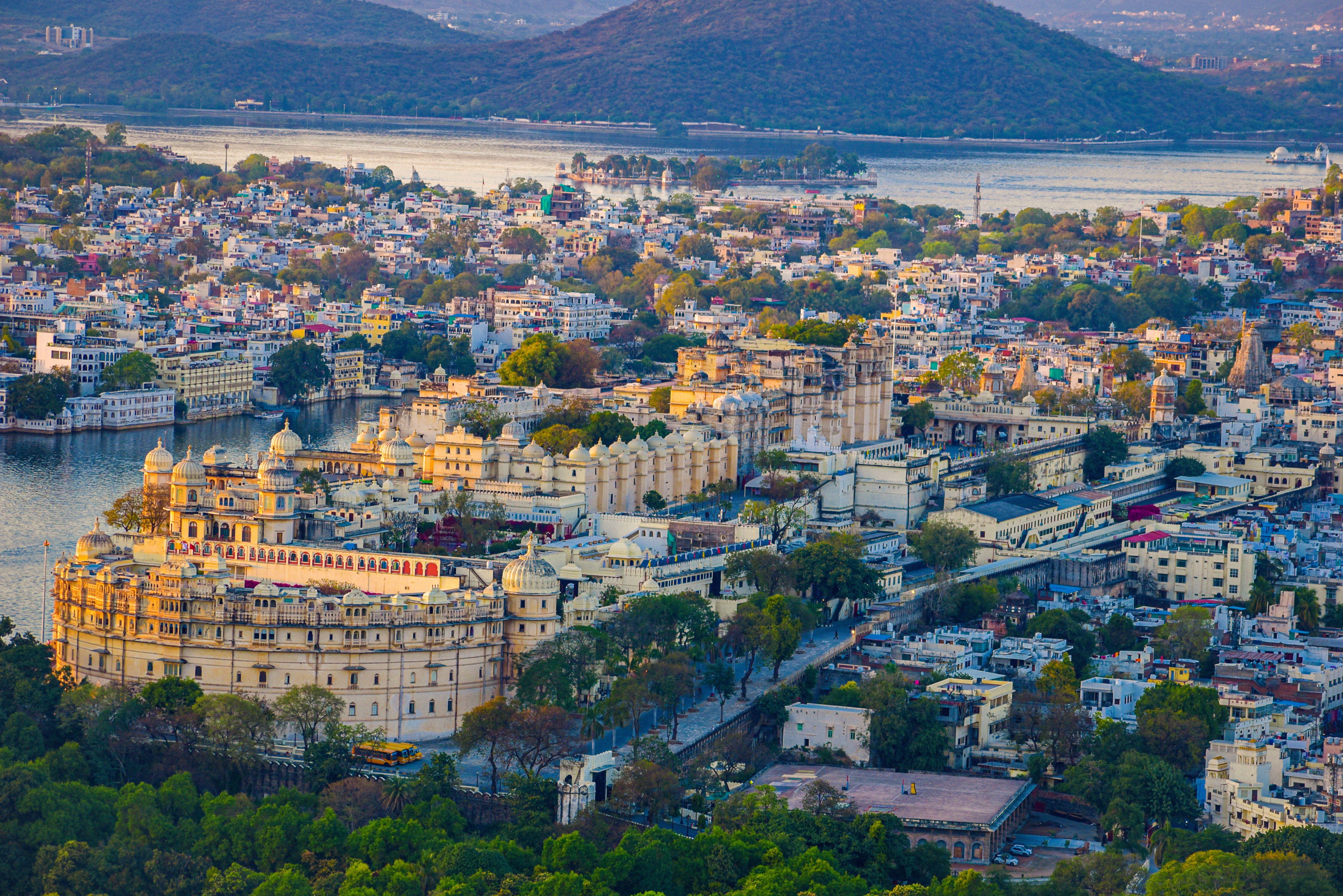 Aerial view of Udaipur City Palace captured by drone, showcasing the grandeur of the historic palace complex against the backdrop of the city