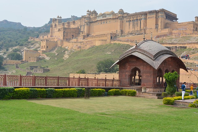 Amer Fort in Jaipur, Rajasthan, captured from the right side, showcasing its majestic architecture and sprawling grounds against the backdrop of the surrounding landscape.