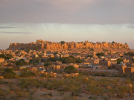 Panoramic view of Jaisalmer Fort against the desert landscape, showcasing its majestic architecture from a distance