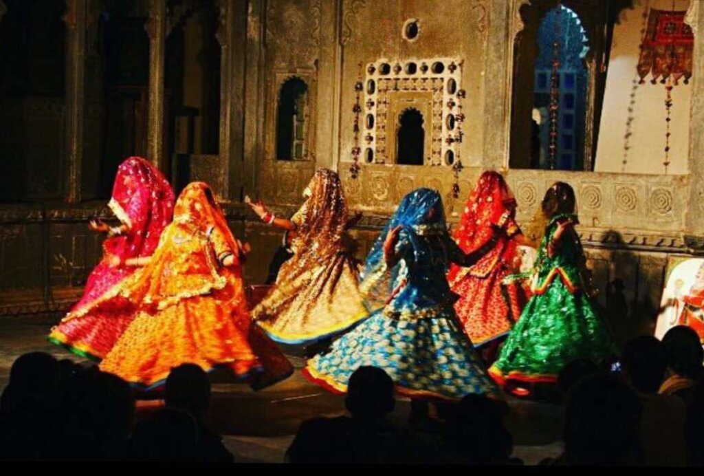 Group of women dressed in traditional attire gracefully performing the Gumar dance, a traditional Rajasthani folk dance.