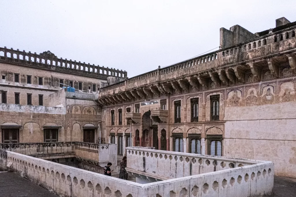  Exterior view of a traditional haveli in Churu, Rajasthan, showcasing intricate architectural details and vibrant colors, reflecting the region's rich cultural heritage.