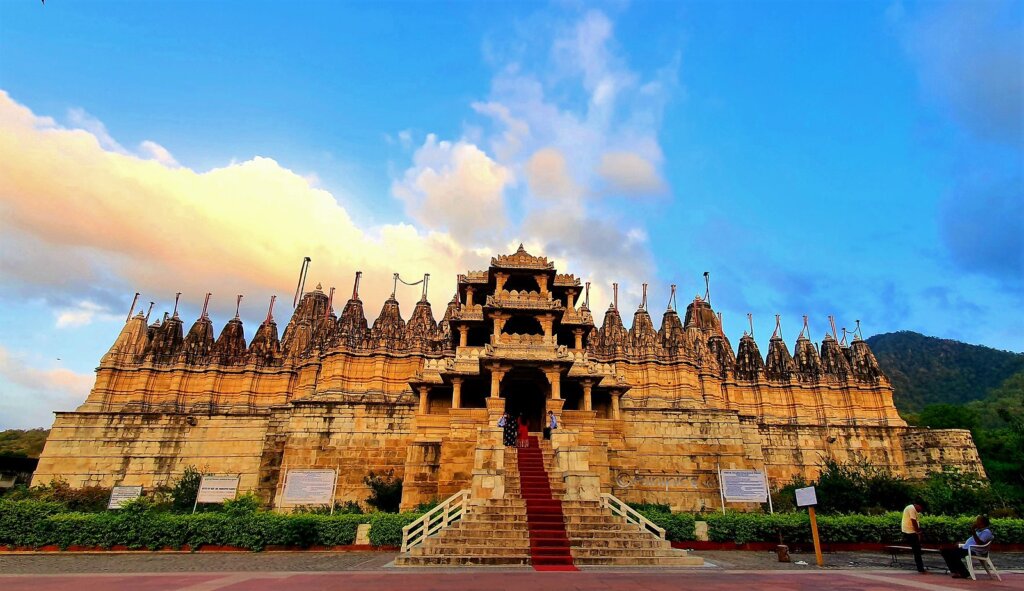 Exterior view of Ranakpur Jain Temple in Rajasthan, showcasing intricate marble carvings and architectural grandeur.