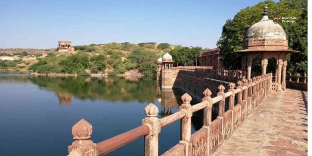 Balsamand Lake in Jodhpur, Rajasthan: A picturesque reservoir surrounded by lush greenery and historical architecture, reflecting the vibrant colors of the sky and surrounding landscape.