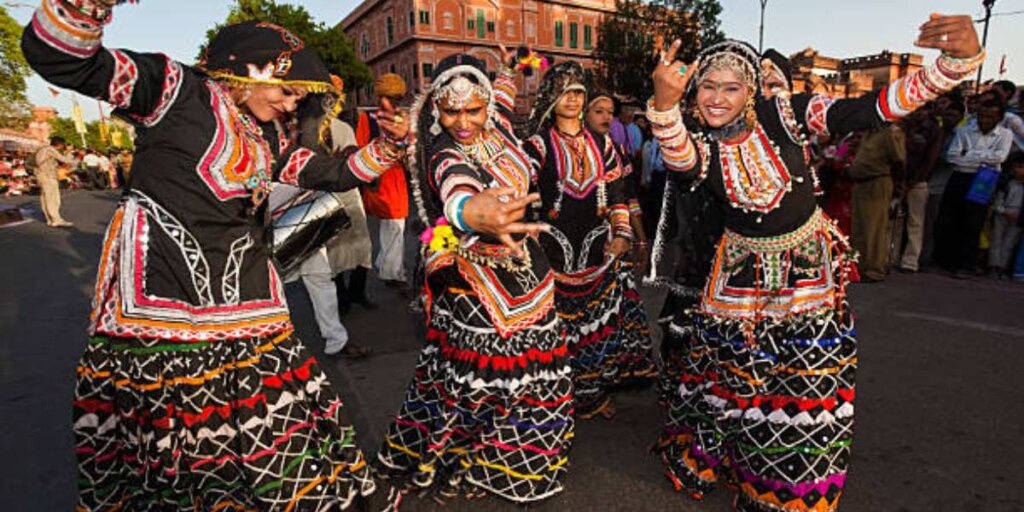  Local artists performing traditional dance during Gangaur celebration, showcasing Rajasthan's vibrant cultural heritage.