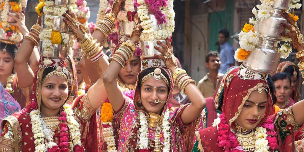 Women carrying small pots on their heads, symbolizing Gangaur procession, a cultural tradition in Rajasthan