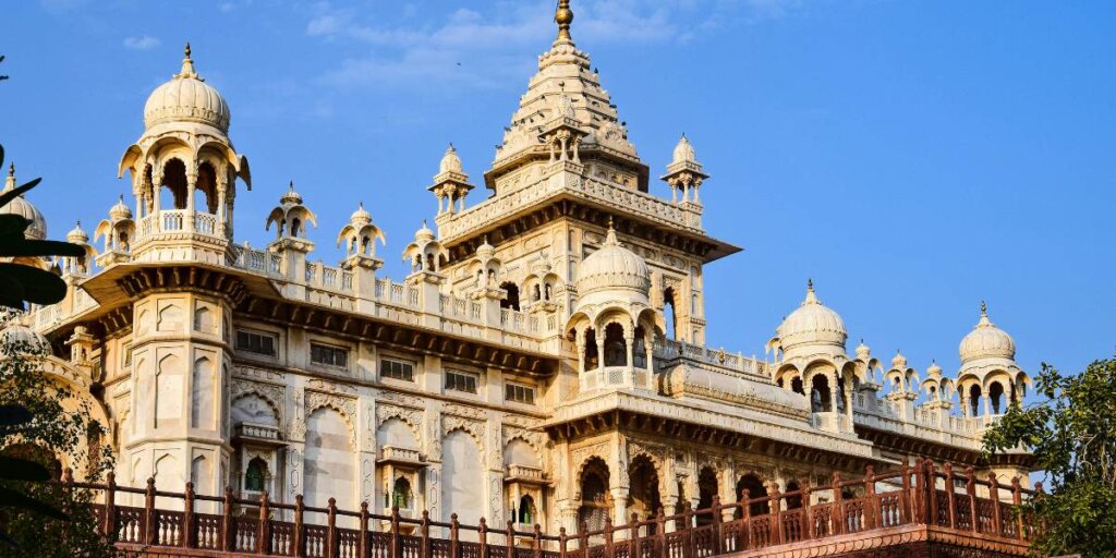 White marble monument of Jaswant Thada in Jodhpur, surrounded by lush greenery. Photo by AXP Photography on Unsplash.