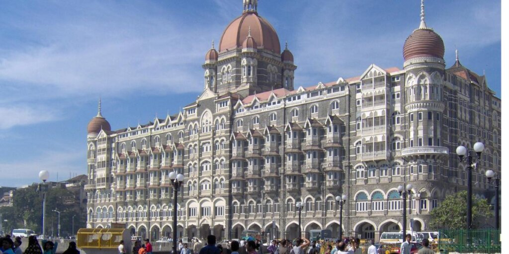 Exterior view of the iconic Taj Hotel in Mumbai showcasing its stunning architecture and surroundings.