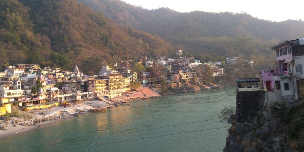 Rishikesh Ganga ghat at Laxman Jhula - Image by Wikimedia: A tranquil tribute to the sacred Ganges River.