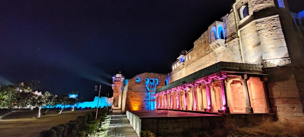 Chittorgarh Fort: Nighttime light and sound show with colorful illuminations against the dark sky, captivates spectators with its historical storytelling.