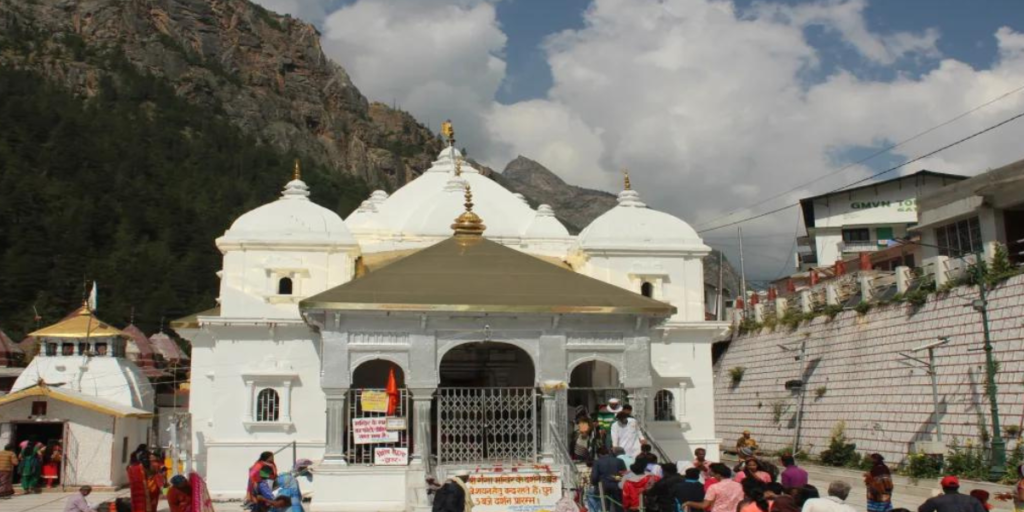 Gangotri Temple, a serene sanctuary nestled in the Himalayas, surrounded by lush greenery and flowing streams, beckoning pilgrims seeking spiritual solace.