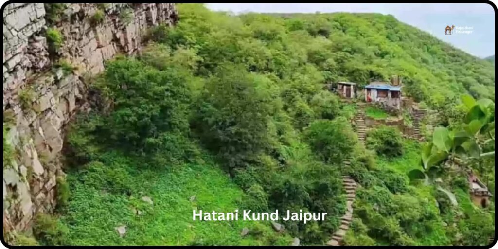 Aerial view of Hatni Kund, an ancient stepwell in Jaipur, India, surrounded by bustling streets and buildings. The stepwell features intricate architectural details, including carved pillars and geometric patterns, with people gathered around its edges.