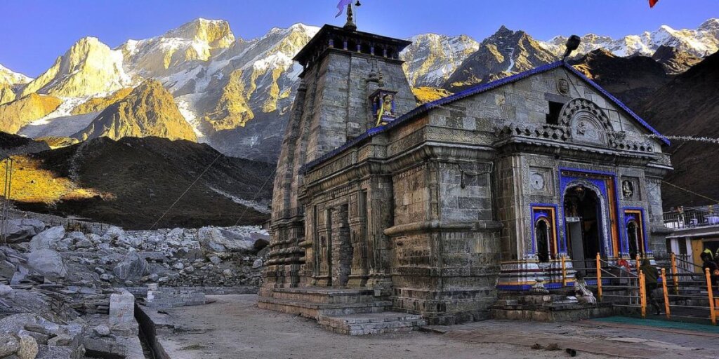 Kedarnath Temple - A serene sanctuary amidst the Himalayas, with snow-clad peaks in the backdrop, captured beautifully in this image by Flickr.