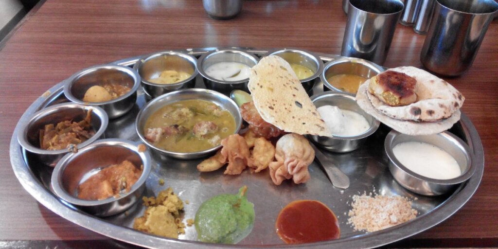 Table filled with colorful Rajasthani dishes, from Wikipedia