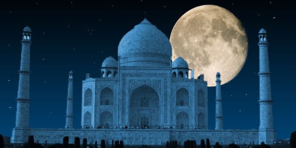 Nighttime view of the Taj Mahal with a full moon, captured by Flickr.