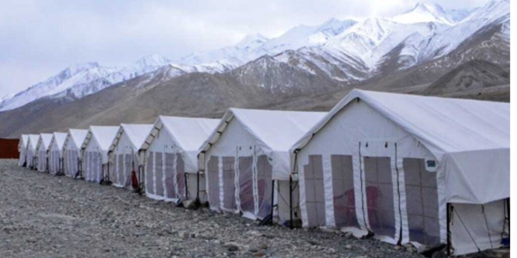 Pangong Lake campsite surrounded by majestic mountains, captured in a captivating image