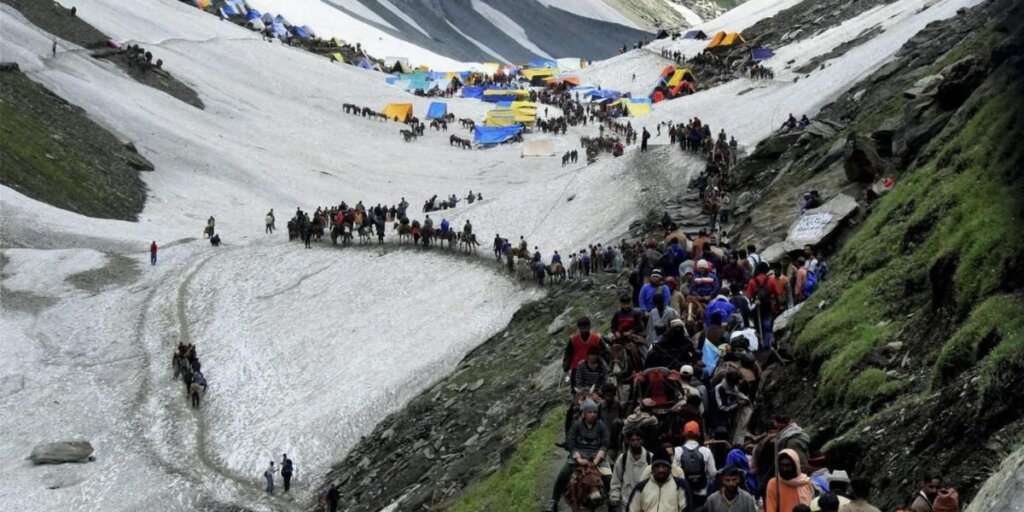  Devotees trekking along the pilgrimage route towards the Amarnath Cave, surrounded by rugged Himalayan terrain.