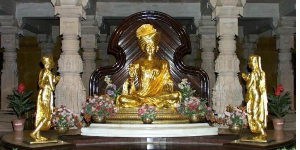 Gandhinagar Akshardham: Interior view of the deity's sculpture inside the majestic Hindu temple complex, showcasing intricate details and spiritual ambiance."