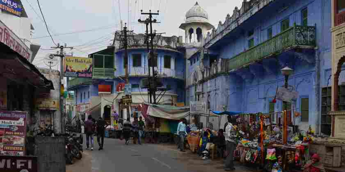 An illustration of the bustling lanes of Pushkar, showcasing ancient shops and vibrant activities.