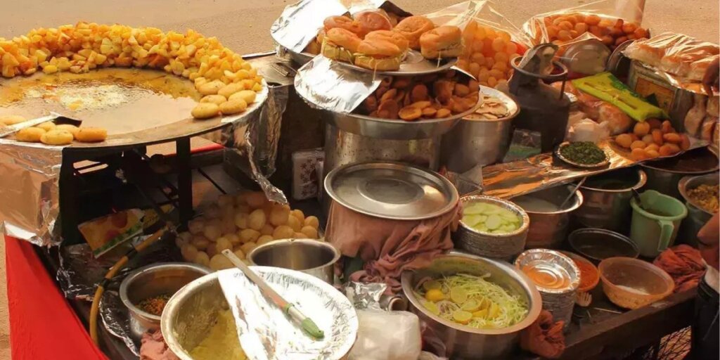 Image of a street food vendor's cart in India, filled with a variety of tempting and flavorful snacks.